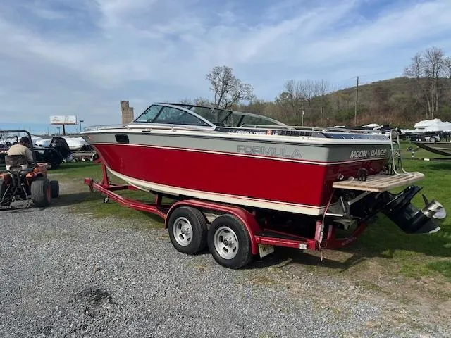 Slide: The Image of 1983 Formula Three LS boat on trailer, red and white, parked outdoors. - 1