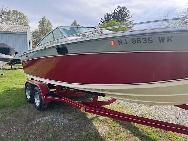 Slide: The Image of 1983 Formula Three LS boat on trailer, red and gray design, parked outdoors. - 3