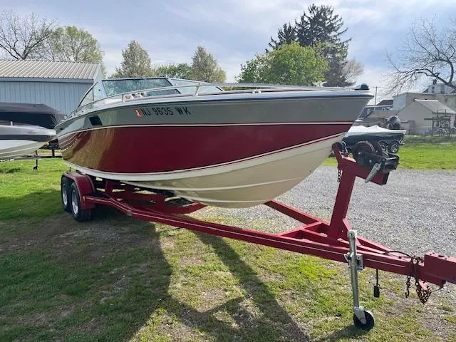 Slide: The Image of 1983 Formula Three LS boat on red trailer, parked outdoors on grass. - 4