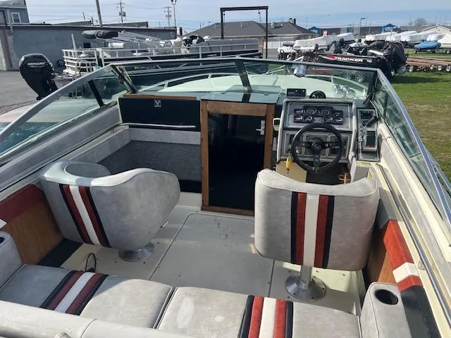 Slide: The Image of 1983 Formula Three LS boat interior with steering wheel, seats, and dashboard controls. - 6