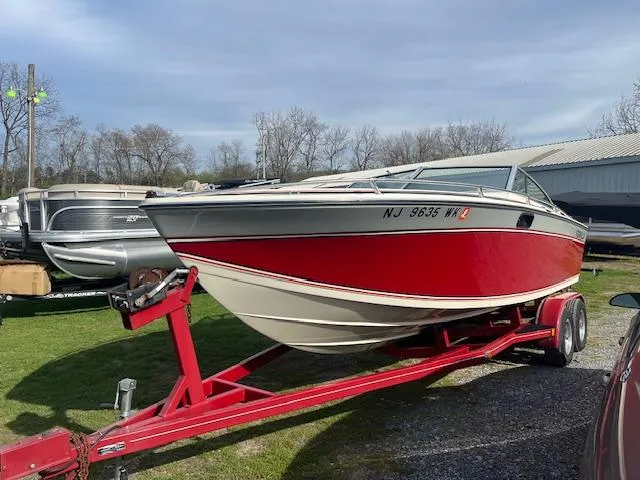 Slide: The Image of 1983 Formula Three LS boat on red trailer, parked outdoors. - 8