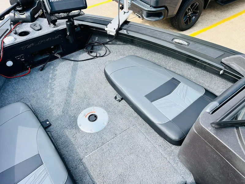 Slide: The Image of 2023 Tracker Targa V-19 WT boat interior with gray seating and fishing equipment. - 13