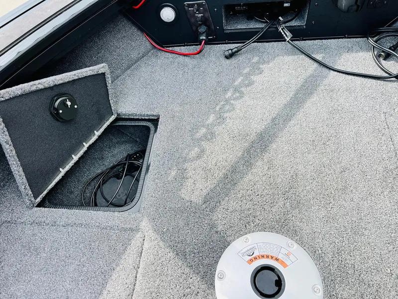 Slide: The Image of 2023 Tracker Targa V-19 WT boat interior with storage compartment and wiring. - 21