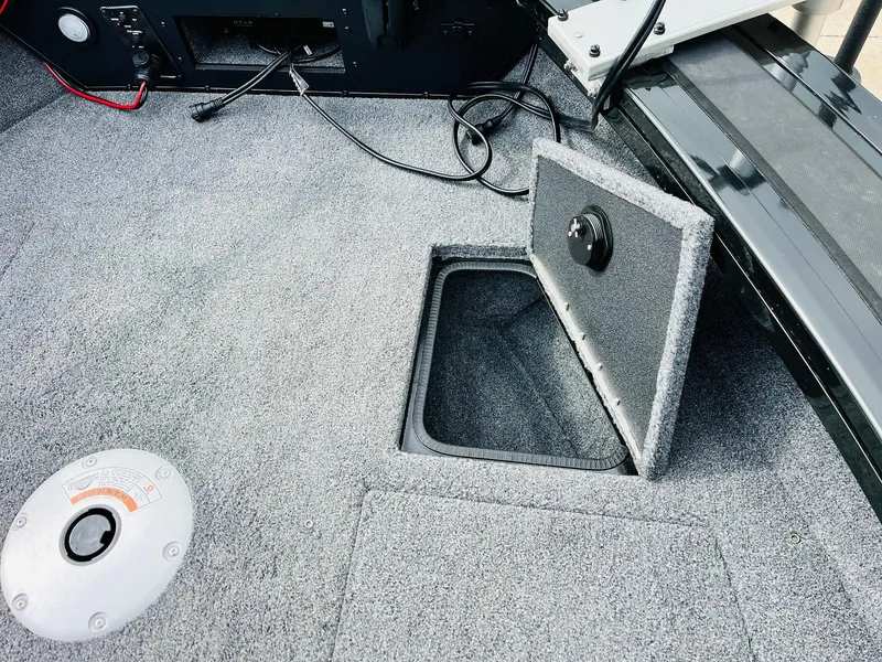 Slide: The Image of 2023 Tracker Targa V-19 WT boat interior with open storage compartment. - 22