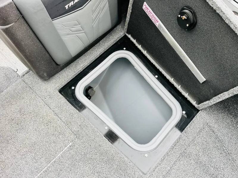 Slide: The Image of 2023 Tracker Targa V-19 WT boat storage compartment with open lid, showcasing interior space. - 23