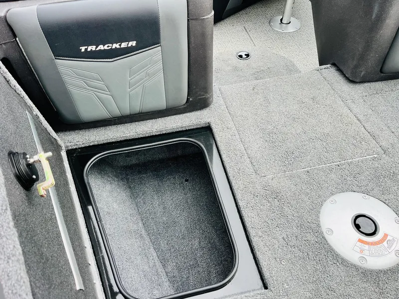 Slide: The Image of 2023 Tracker Targa V-19 WT boat interior with storage compartment and seating. - 24