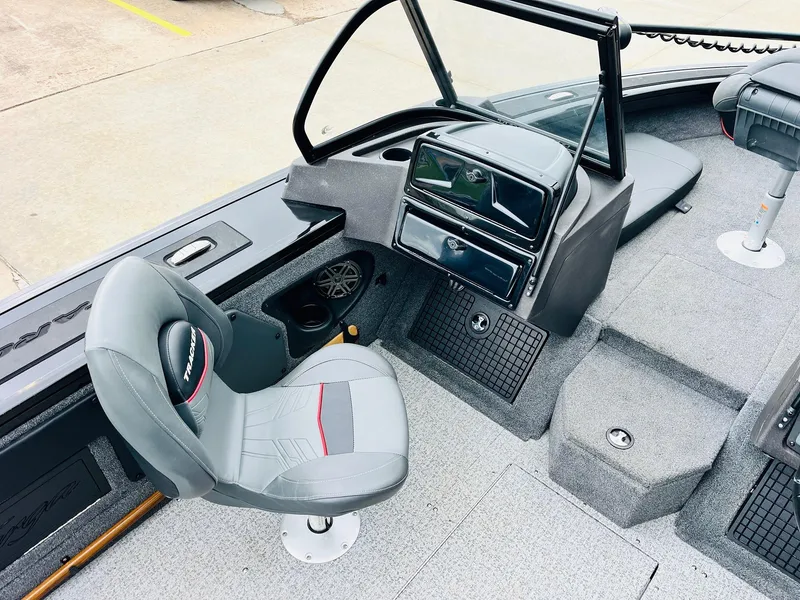 Slide: The Image of 2023 Tracker Targa V-19 WT boat interior with gray seating and dashboard. - 27