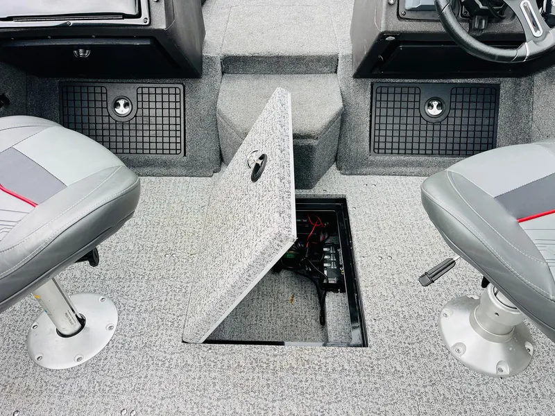 Slide: The Image of 2023 Tracker Targa V-19 WT boat interior with open storage compartment between seats. - 34