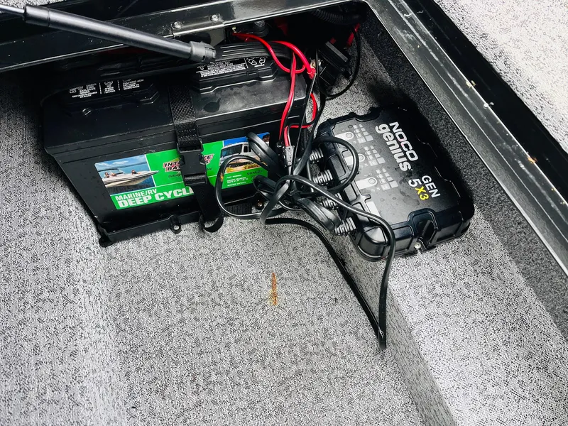 Slide: The Image of 2023 Tracker Targa V-19 WT boat battery compartment with Noco Genius charger. - 35