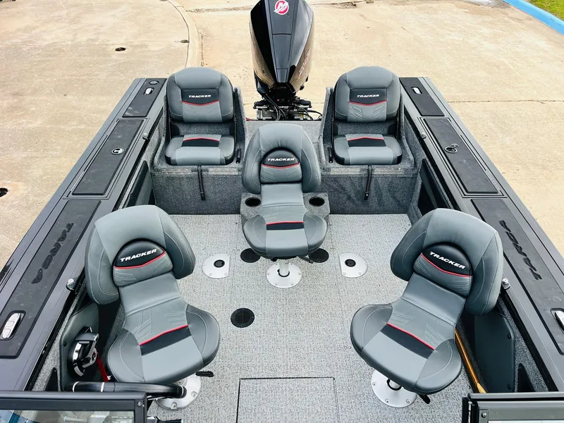 Slide: The Image of 2023 Tracker Targa V-19 WT boat interior with five gray seats and motor. - 43