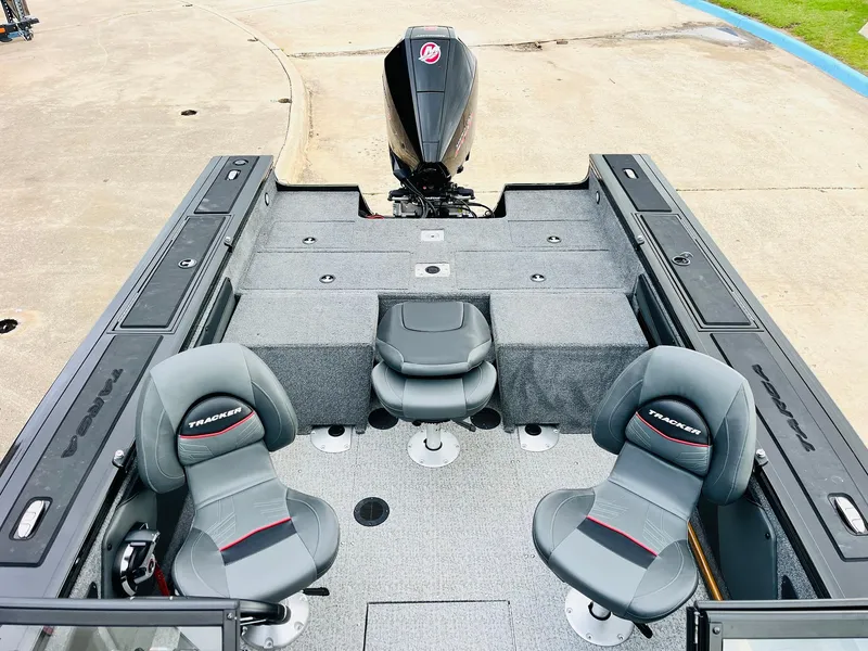 Slide: The Image of 2023 Tracker Targa V-19 WT boat interior with seating and motor, viewed from above. - 44