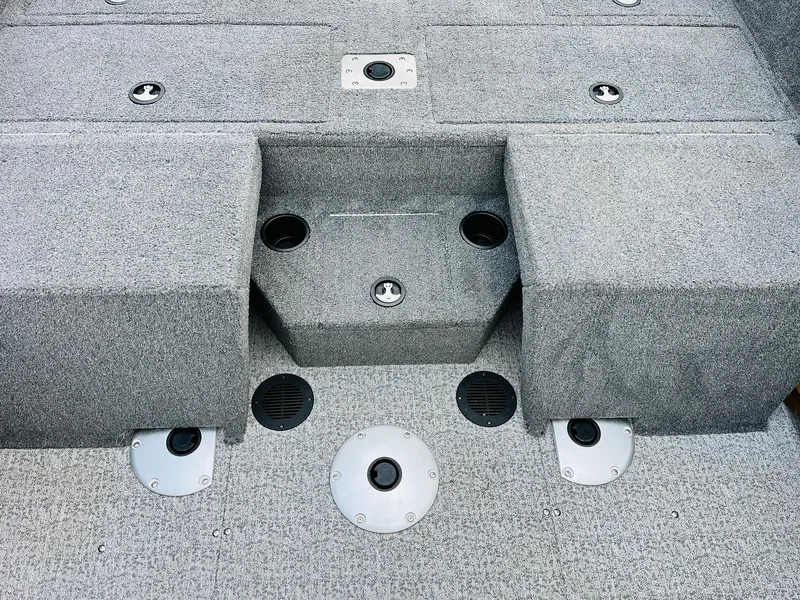 Slide: The Image of 2023 Tracker Targa V-19 WT boat interior with gray carpeted deck and storage compartments. - 47