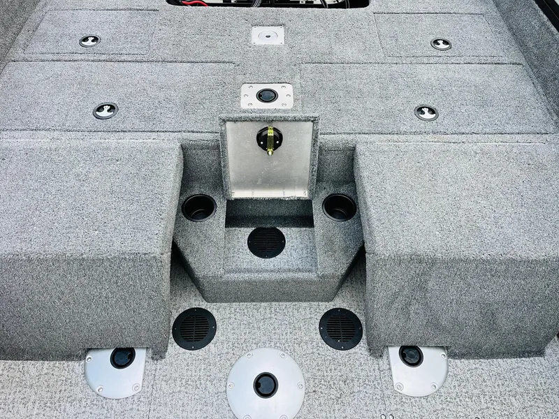 Slide: The Image of 2023 Tracker Targa V-19 WT boat interior with gray carpet and storage compartments. - 48