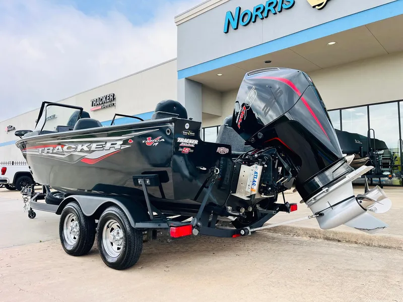 Slide: The Image of 2023 Tracker Targa V-19 WT boat with powerful outboard motor, parked outside dealership. - 7