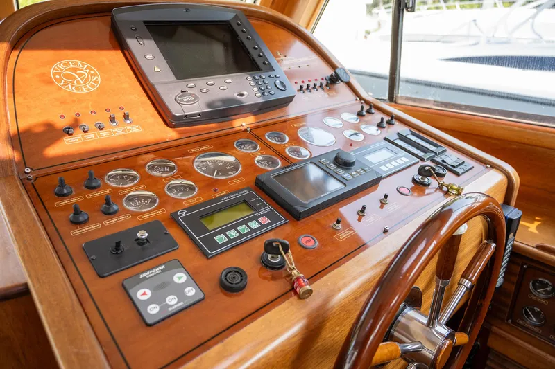 Slide: The Image of Control panel of a 2003 Vicem 51 Classic yacht with wooden finish and navigation instruments. - 14