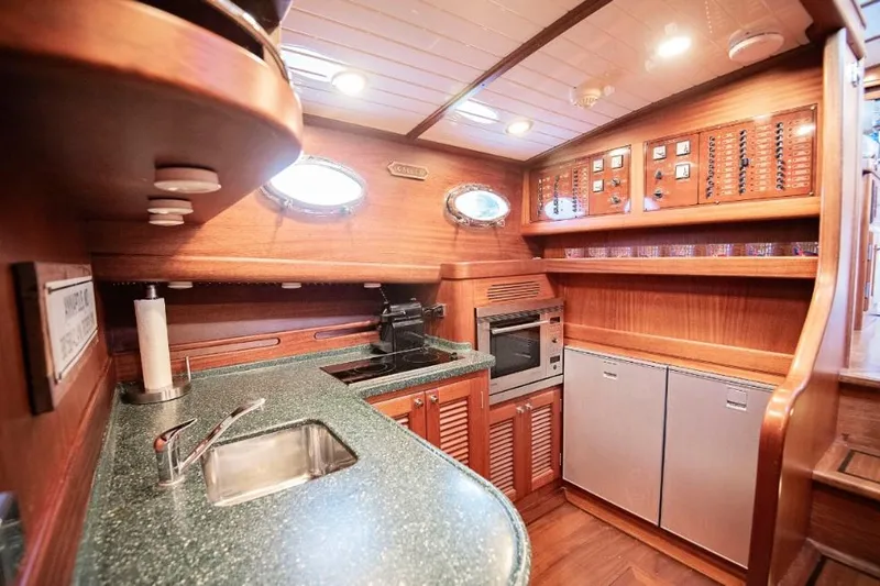 Slide: The Image of Luxurious 2003 Vicem 51 Classic yacht kitchen with wood cabinetry and modern appliances. - 16
