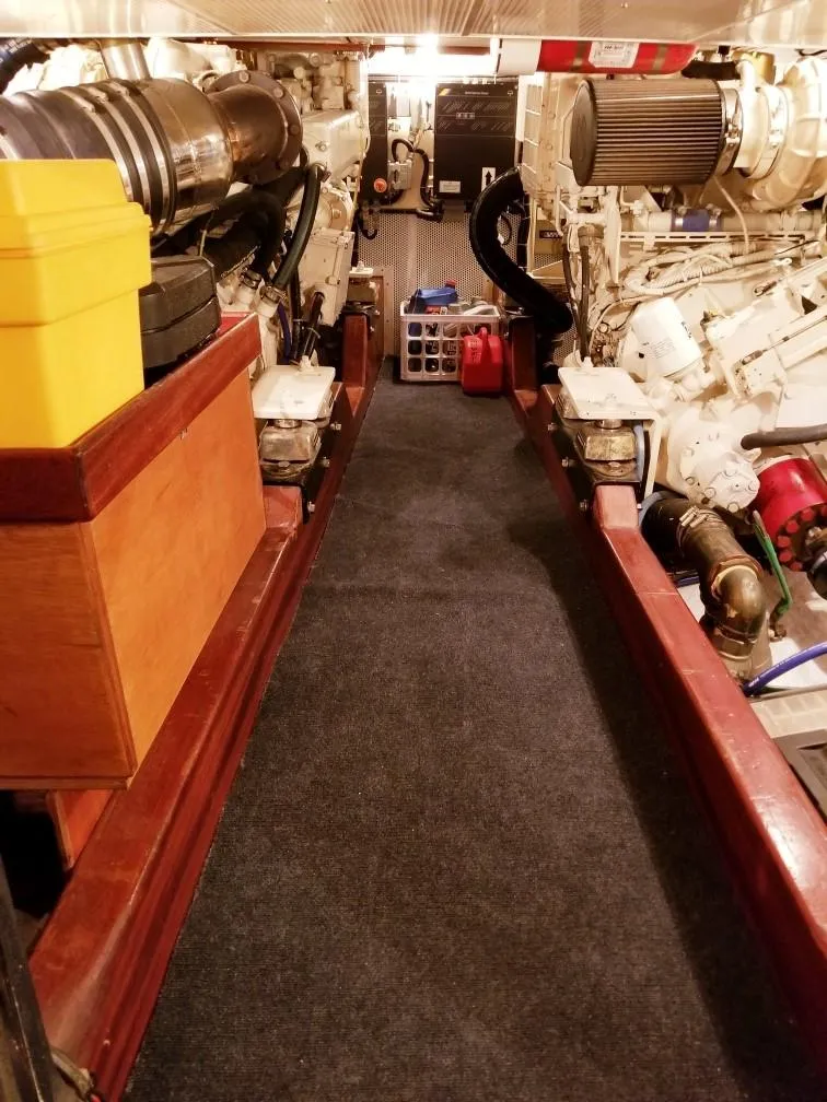 Slide: The Image of Engine room of 2003 Vicem 51 Classic yacht, featuring dual engines and organized storage. - 28