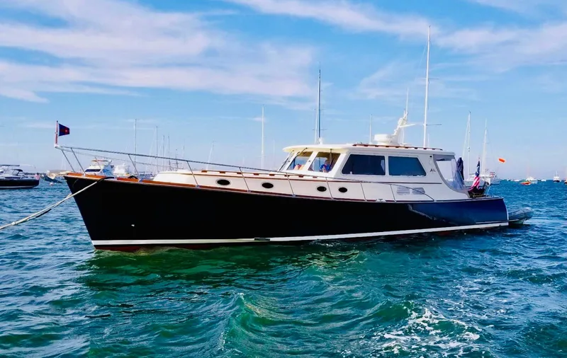 Slide: The Image of 2003 Vicem 51 Classic yacht on clear blue water under a sunny sky. - 6