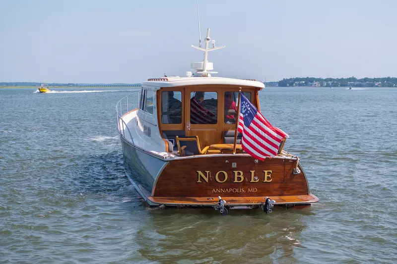 Slide: The Image of 2003 Vicem 51 Classic yacht "Noble" on water, Annapolis, MD, with American flag. - 7