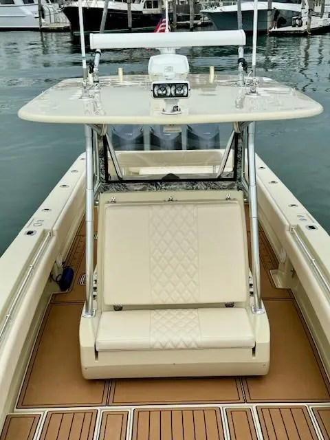 Slide: The Image of 2010 Contender 39 Tournament boat with beige seating and deck, docked in a marina. - 4
