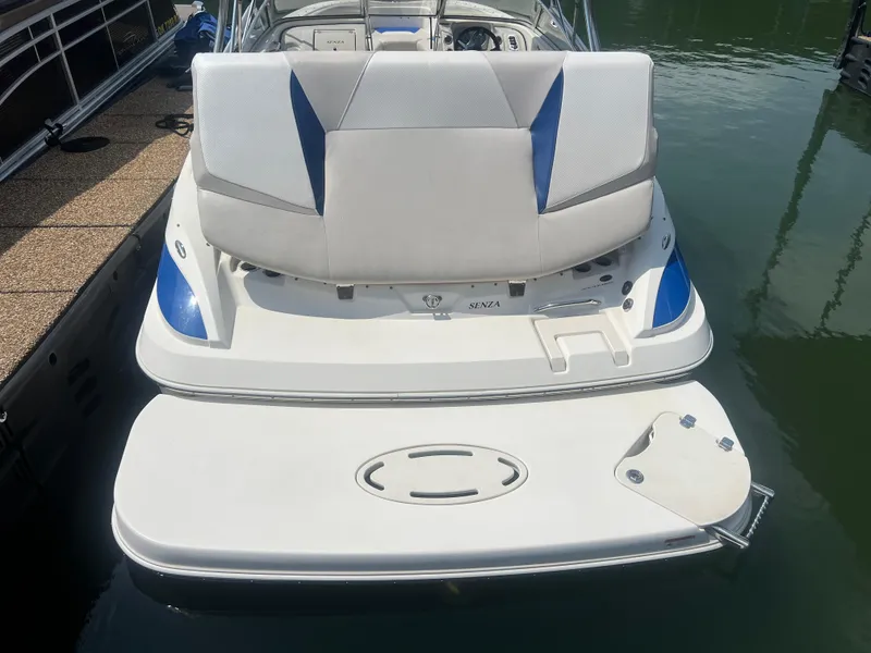 Slide: The Image of 2006 Larson Senza 206 boat with swim platform, docked on calm water. - 12