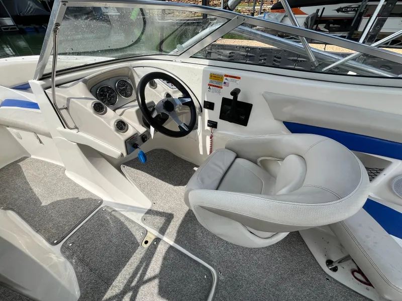 Slide: The Image of 2006 Larson Senza 206 boat interior with steering wheel and seating. - 14