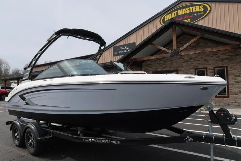The Image of 2025 Chaparral 21 SSi boat on trailer outside dealership. - 1