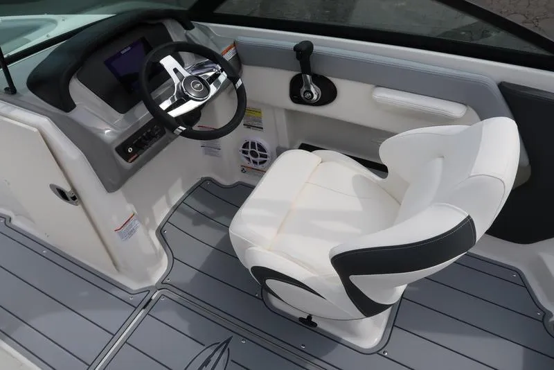 Slide: The Image of 2025 Chaparral 21 SSi boat interior with steering wheel and captain's chair. - 23