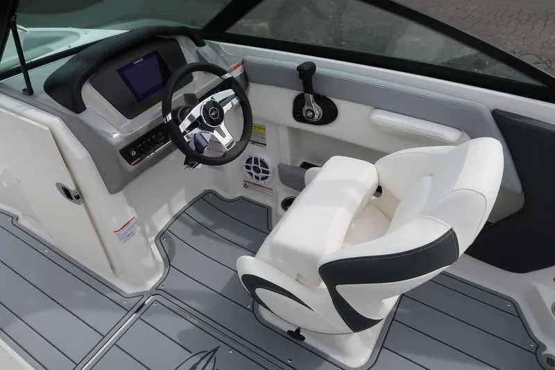 Slide: The Image of Interior of 2025 Chaparral 21 SSi boat featuring steering wheel and captain's chair. - 24