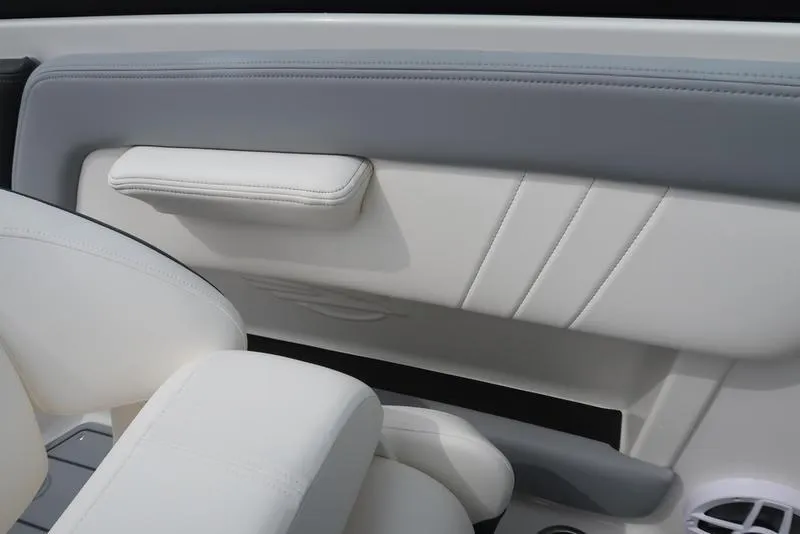 Slide: The Image of Interior of 2025 Chaparral 21 SSi boat, featuring sleek white and gray seating. - 27