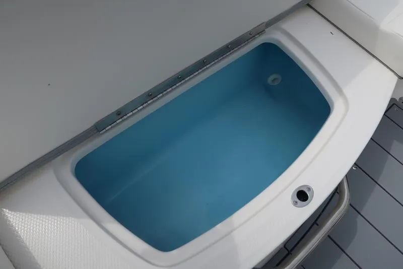 Slide: The Image of 2025 Chaparral 21 SSi boat storage compartment with blue interior. - 32