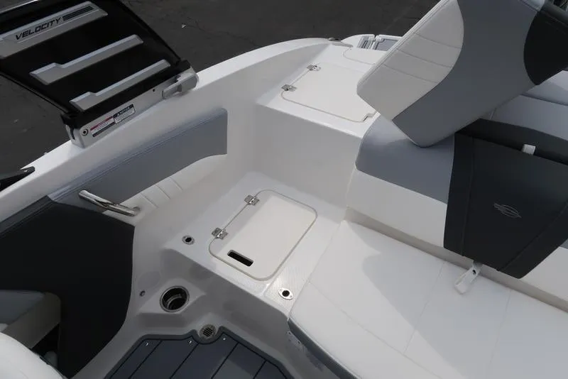 Slide: The Image of 2025 Chaparral 21 SSi boat interior with white and gray seating and storage compartments. - 33