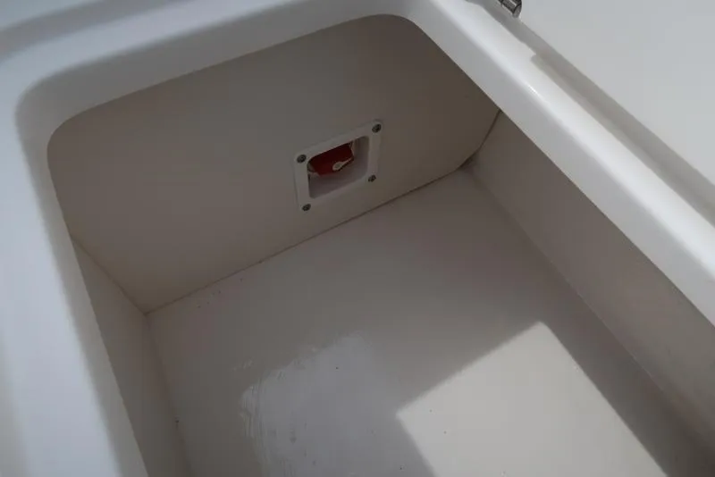 Slide: The Image of Storage compartment of 2025 Chaparral 21 SSi boat, featuring a clean, white interior. - 36