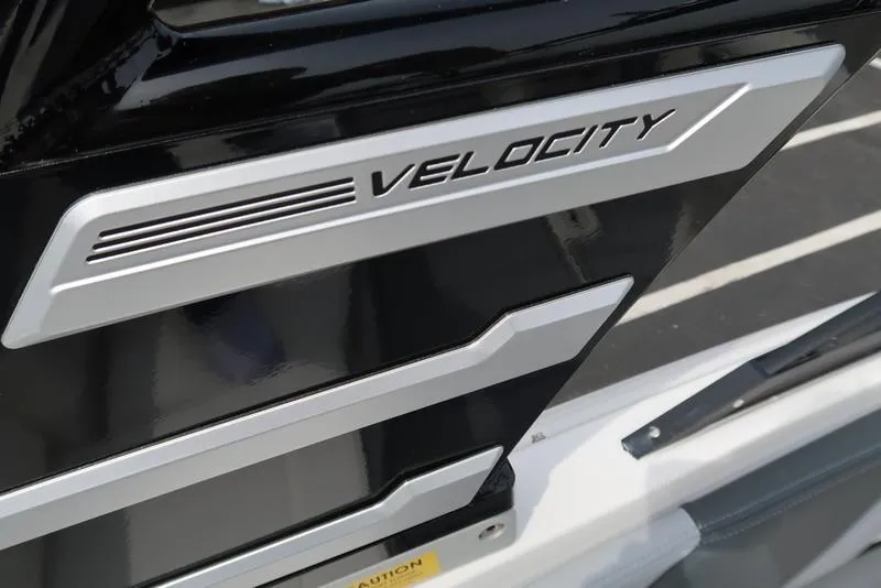 Slide: The Image of 2025 Chaparral 21 SSi boat detail with "Velocity" branding on sleek black surface. - 44