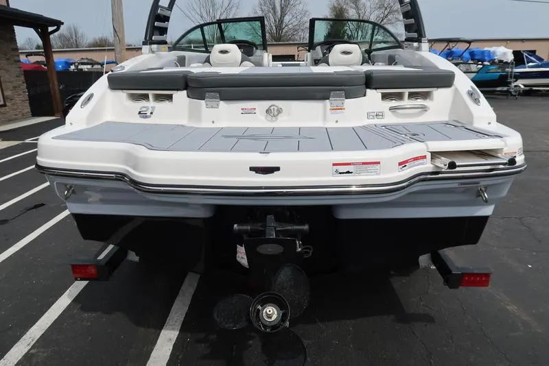 Slide: The Image of 2025 Chaparral 21 SSi boat rear view, showcasing swim platform and outboard motor. - 46