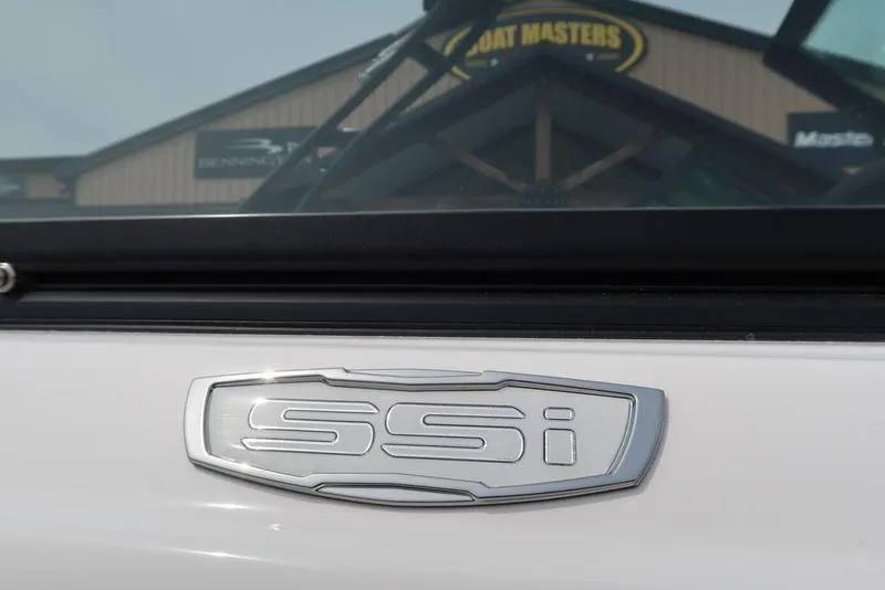 Slide: The Image of 2025 Chaparral 21 SSi boat emblem close-up with dealership background. - 49