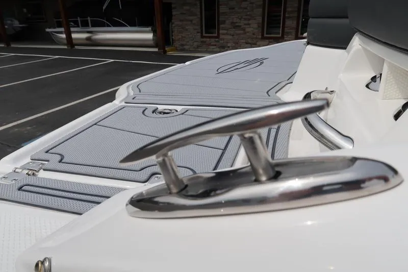 Slide: The Image of 2025 Chaparral 21 SSi boat cleat and deck detail in a parking area. - 53