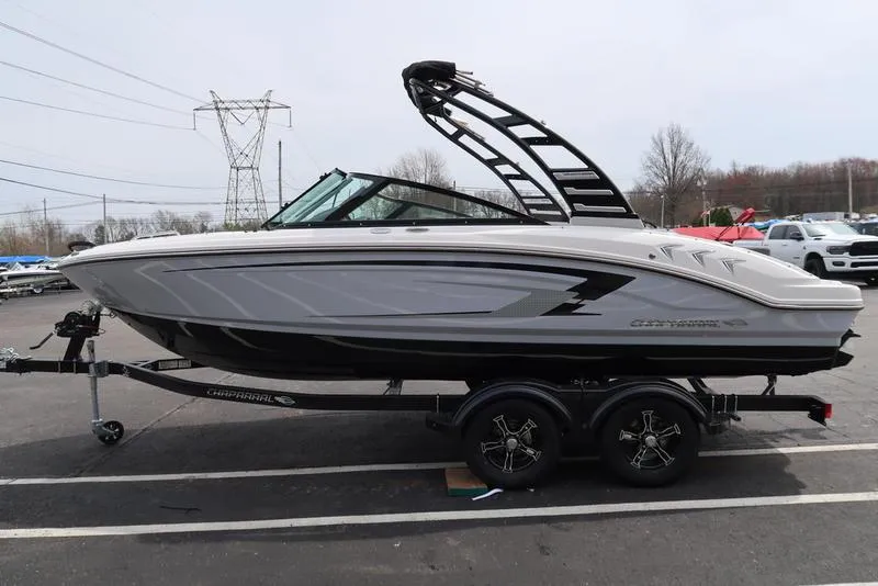 Slide: The Image of 2025 Chaparral 21 SSi boat on trailer, sleek design, parked outdoors. - 7