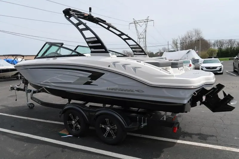 Slide: The Image of 2025 Chaparral 21 SSi boat on trailer, parked outdoors, side view. - 8