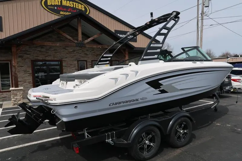 Slide: The Image of 2025 Chaparral 21 SSi boat on trailer outside dealership. - 9