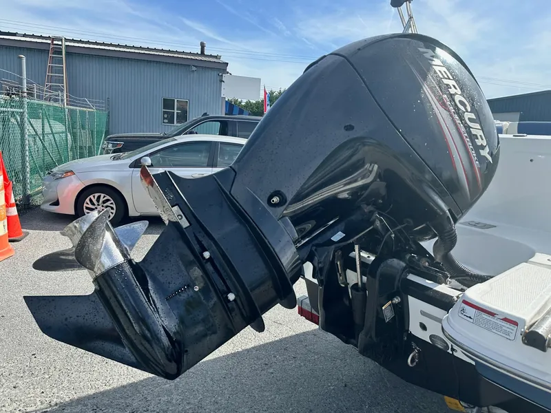 Slide: The Image of 2016 Tahoe 2150 Deck Boat with Mercury outboard motor in a parking lot. - 13
