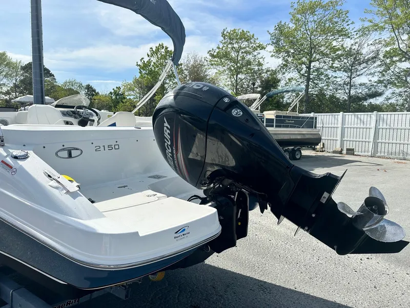 Slide: The Image of 2016 Tahoe 2150 Deck Boat with Mercury outboard motor in a sunny outdoor setting. - 4