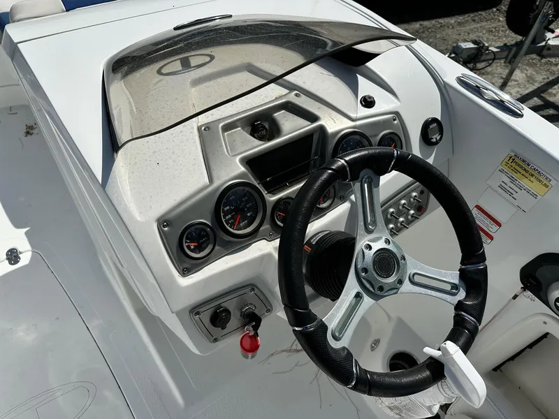 Slide: The Image of Steering console of a 2016 Tahoe 2150 Deck Boat with gauges and controls. - 6