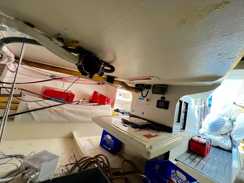 Slide: The Image of Interior of a 1989 Custom Modified SLP 52 boat, showing equipment and storage. - 21