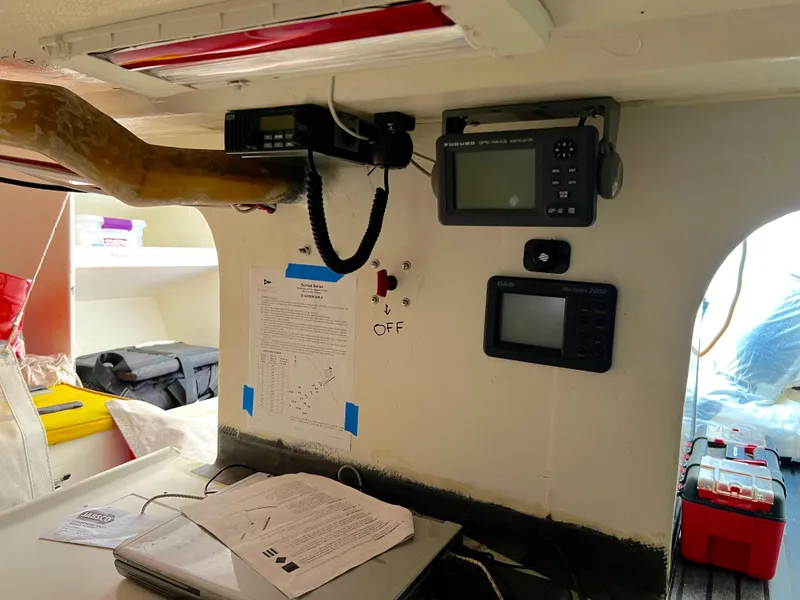 Slide: The Image of Interior of a 1989 Custom Modified SLP 52 boat with navigation equipment and documents. - 22