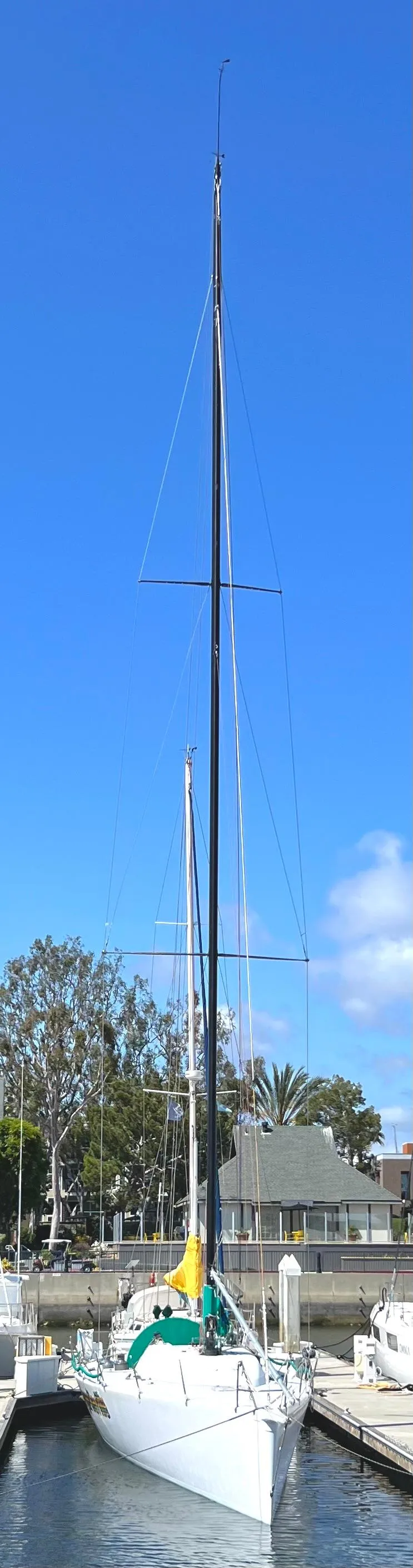 Slide: The Image of Sailboat docked at marina, Custom Modified In 2003 SLP 52, clear blue sky. - 33