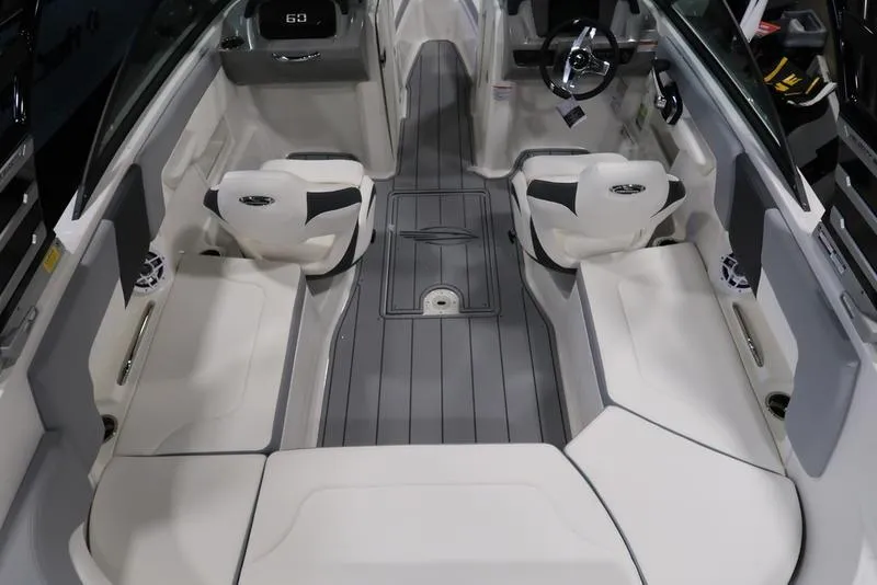 Slide: The Image of 2025 Chaparral 23 SSi boat interior with sleek seating and modern dashboard design. - 13