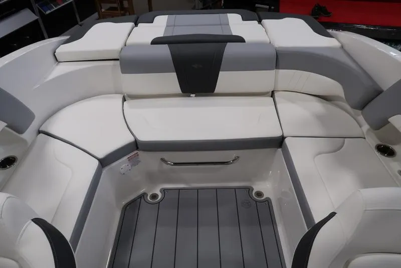 Slide: The Image of 2025 Chaparral 23 SSi boat interior with white and gray seating arrangement. - 14