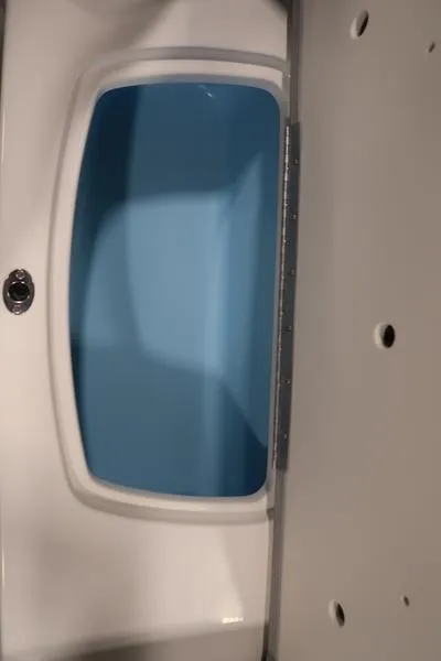 Slide: The Image of 2025 Chaparral 23 SSi boat storage compartment with blue interior. - 16