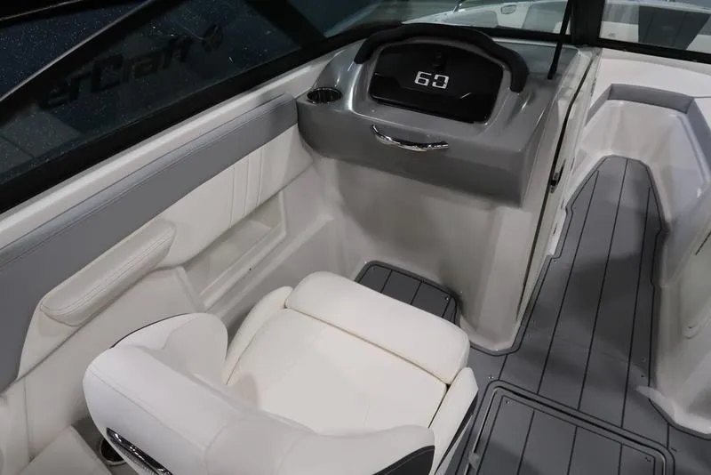 Slide: The Image of 2025 Chaparral 23 SSi boat interior with modern dashboard and comfortable seating. - 21